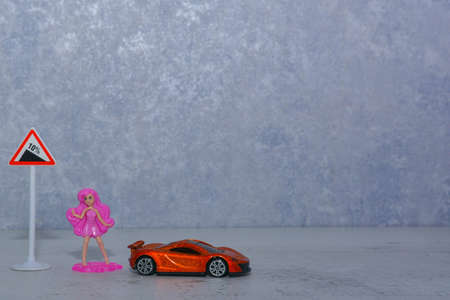 toy girl next to road signs and equipmentの写真素材