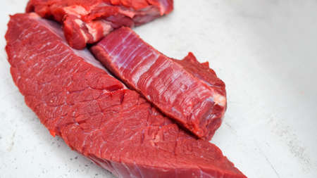 raw meat on the cutting table, cooking minced meat in the kitchen with a meat grinderの写真素材