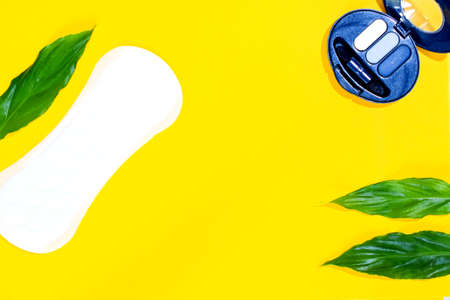 women's perfumes and cosmetics with plant leaves on a colored backgroundの写真素材