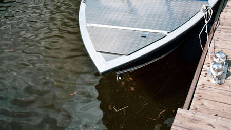 boat on the water at the pier in spring on a clear dayの写真素材