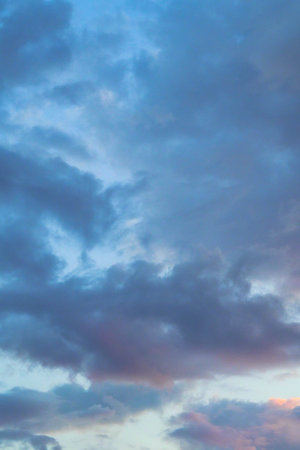 Clouds in the blue sky at sunset as an abstract background.