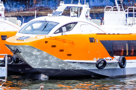 Orange and white motor boat in the harbor of Riga, Latviaの写真素材
