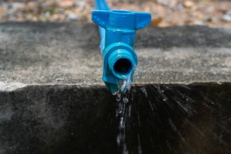 Water flows from a water pipe.の写真素材