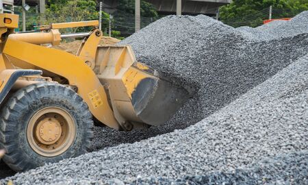 Wheel loader Excavator unloading rockの写真素材