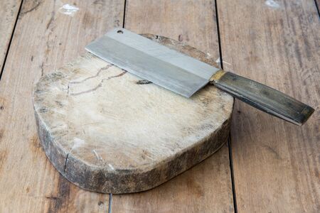 Kitchen knife on a wooden cutting board.