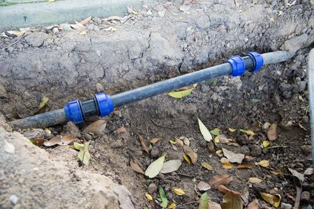 Water PVC Plastic Pipes in Ground during Plumbing Construction siteの写真素材