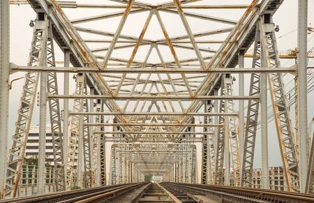 Railroad bridge of steel, inside view passes over the river.の写真素材
