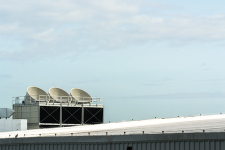 Communication Satellite dish on the roof on a building.の写真素材