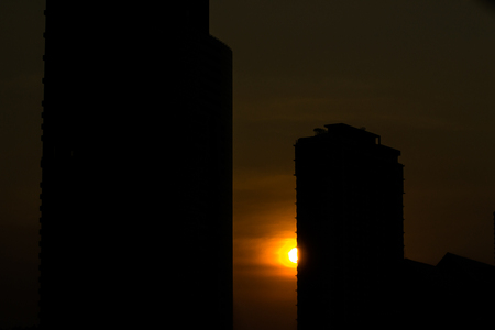silhouette sunset at building in cityの写真素材