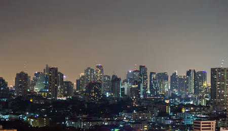 a view over the big asian city of Bangkok , Thailand at nighttime when the tall skyscrapers are...