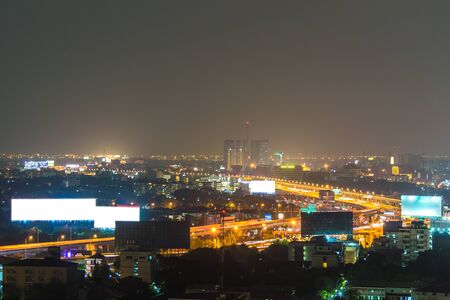 a view over the big asian city of Bangkok , Thailand at nighttime when the tall skyscrapers are illuminated.の写真素材