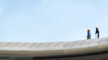 Roofers on the roof construction workerの写真素材