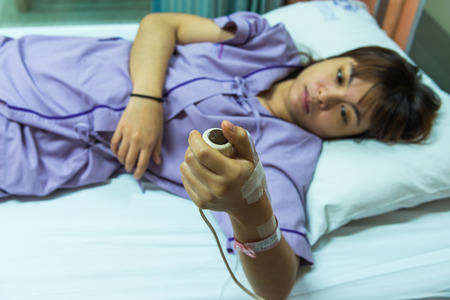 Woman patient sleeping in hospital bed.の写真素材