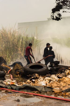 Firemen using water hose on fireの写真素材