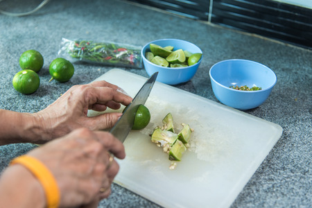 Sliced lemons with a kitchen knife on cutting boards.の写真素材