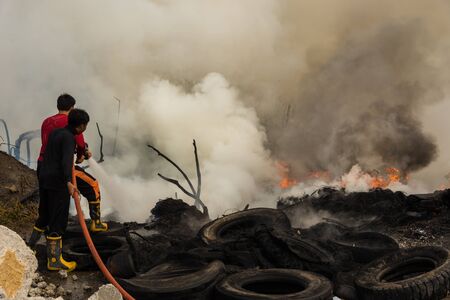 Nonthaburi, Thailand - March 11, 2017 : Firemen fighting the fire at wilderness area in Thailand