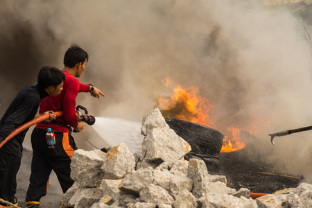 Nonthaburi, Thailand - March 11, 2017 : Firemen fighting the fire at wilderness area in Thailandのeditorial素材