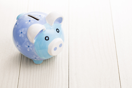 Piggy bank on a white tableの写真素材
