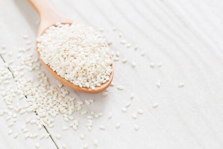 white sesame seeds on wooden spoon,Healthy Foodの写真素材