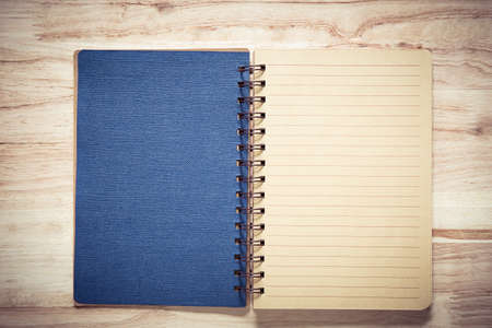Top view of open notebook with two blank pages on wooden backgroundの写真素材