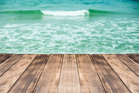 Old wood table top on blurred beach background,Space available for the product