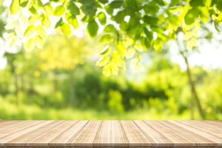 Emply table top on blurred nature background,Space for placing productsの写真素材