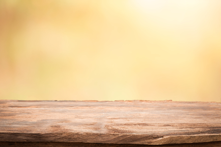Empty table top on blurred nature background,Space for placing products,Warm light from the sunsetの写真素材
