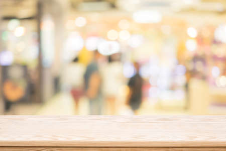 wood coordination table top on shoppingmall blurred background,Space available for the productの写真素材