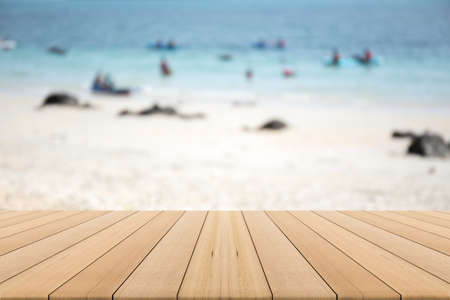 wood table top on blurred beach background,Space available for the productの写真素材