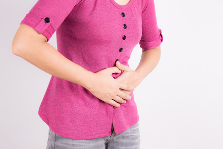 Asian women with abdominal pain on white backgroundの写真素材