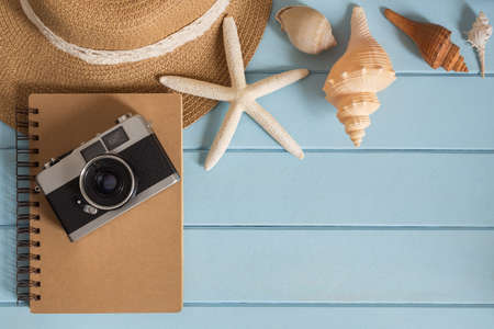 camera and shells on the wooden floor of the blue,summer conceptの写真素材