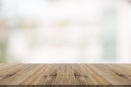 Wood table top on white blurred background from building,for montage your productsの写真素材