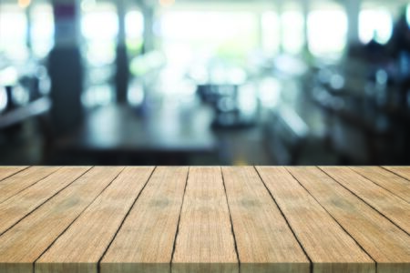 Empty wood table top on blurred background at coffee shop,space for montage productsの写真素材