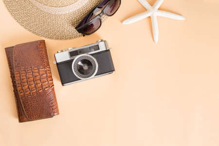 Film camera and hat on a yellow background,travel concept top viewの写真素材