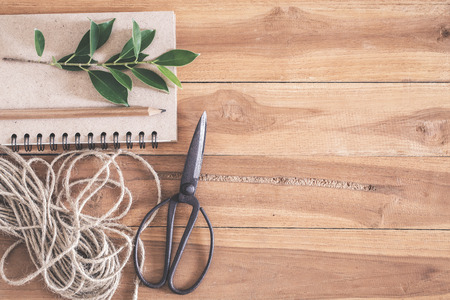 Old scissors notebook and ropes on wooden floorの写真素材