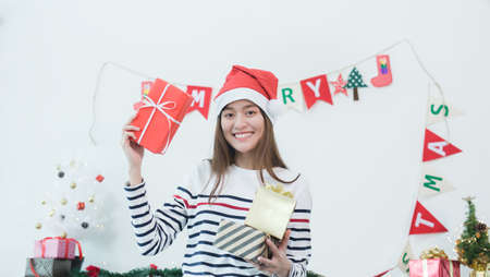 Happy young asian woman with christmas gifts