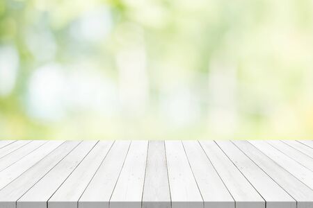 White table top on green blurred background,space for montage productの写真素材