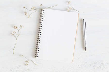 Flat lay photo of office desk on white background,empty notebook open on white wood tableの写真素材