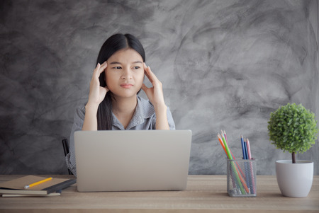 Asian women stressful working with a computer for a long time,Office syndrome concept