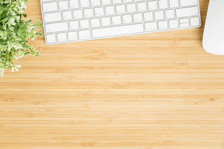 Flat lay photo of office desk with mouse and keyboard ,Top view workpace on bamboo wood table and...
