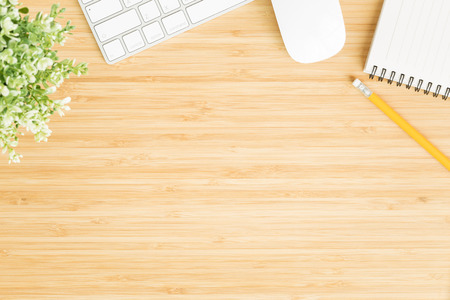 Flat lay photo of office desk with mouse and keyboard ,Top view workpace on bamboo wood table and copy spaceの写真素材