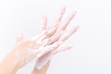 Asian woman hand are washing with soap bubbles on white background, Health and Lifestyle Concepts, Global Handwashing Dayの写真素材