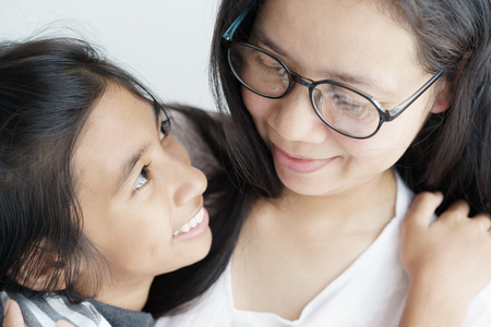 Asian woman hugging cute a girl. Mother and a daughter are smile be happy family.の写真素材