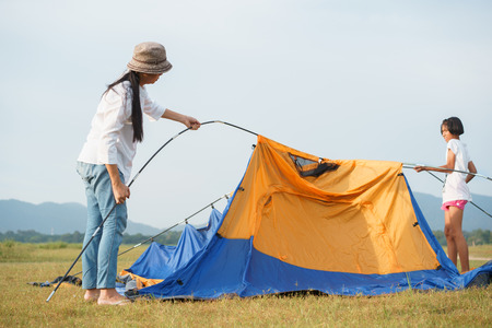 Asian families with mothers and children Traveling to relax, being a tent for relaxation, The concept of family lifestyle on holidaysの写真素材