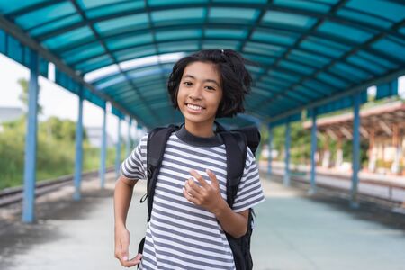 Asian kid girl is walking to school while carrying a backpack, Back to school concept