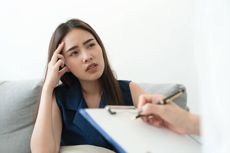 Asian women have headache are sick. So she went to see a doctor to check the symptoms. Health and...