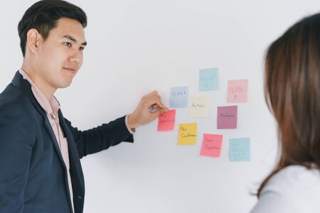Two of business people meeting in the office and using notes to share the idea and group planning...