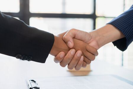 Real estate broker agent Shake hands after customer signing contract document for ownership realty purchase in the office, Business concept and  signing contract

の写真素材