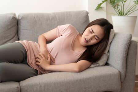 Asian women with menstrual pain at abdomen and the face expression.の写真素材