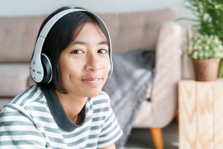 Portrait of Asian little girl happy and smile while sitting in at home morning and looking to cameraの写真素材